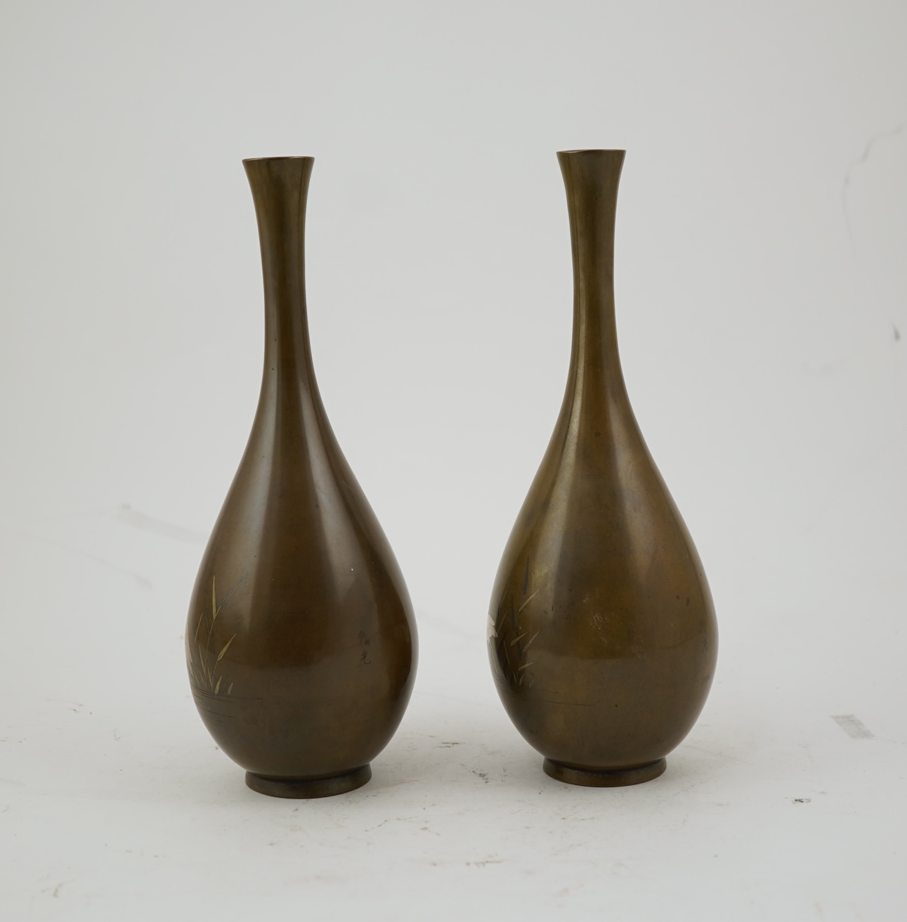 A pair of Japanese bronze and mixed metal inlaid bottle vases, signed Hidemitsu, Meiji period